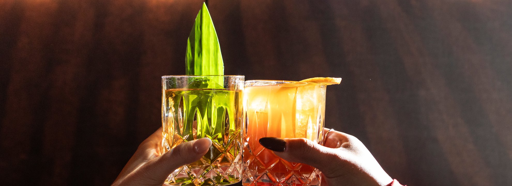 photo of two signature cocktails in front of selva sign at the emily hotel chicago